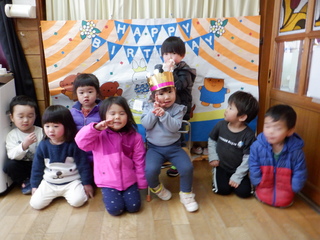 2歳児クラスの女の子を囲んでお祝いしています。