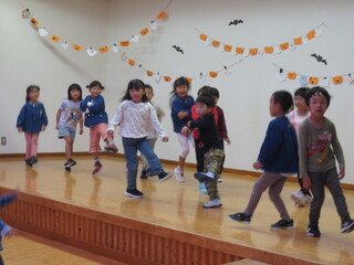 ５歳児がステージに立ってダンスを踊っています