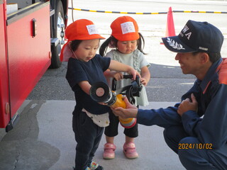 1歳児が消火器を持っています